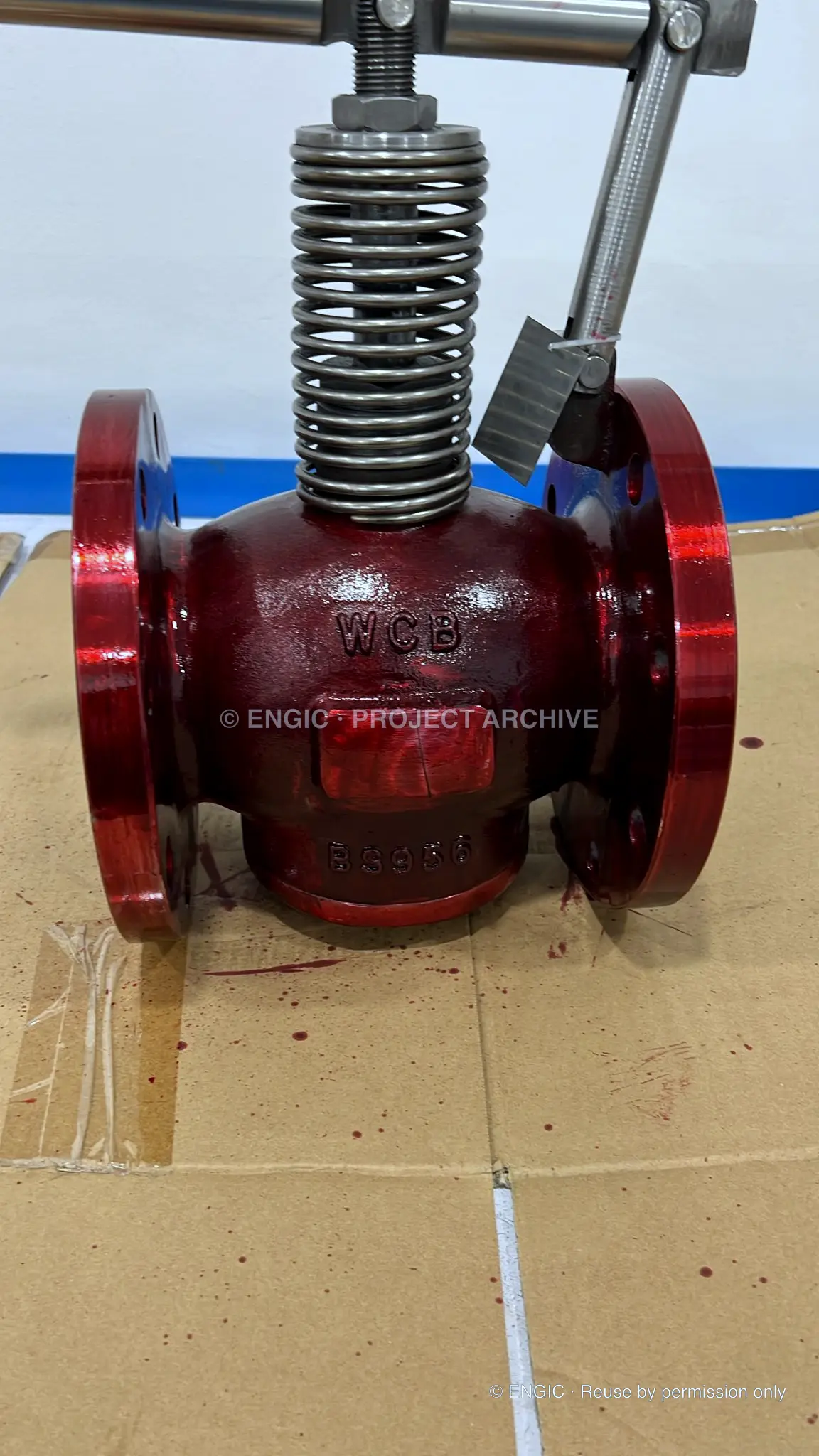 Red penetrant applied to a valve body during visible dye penetrant inspection