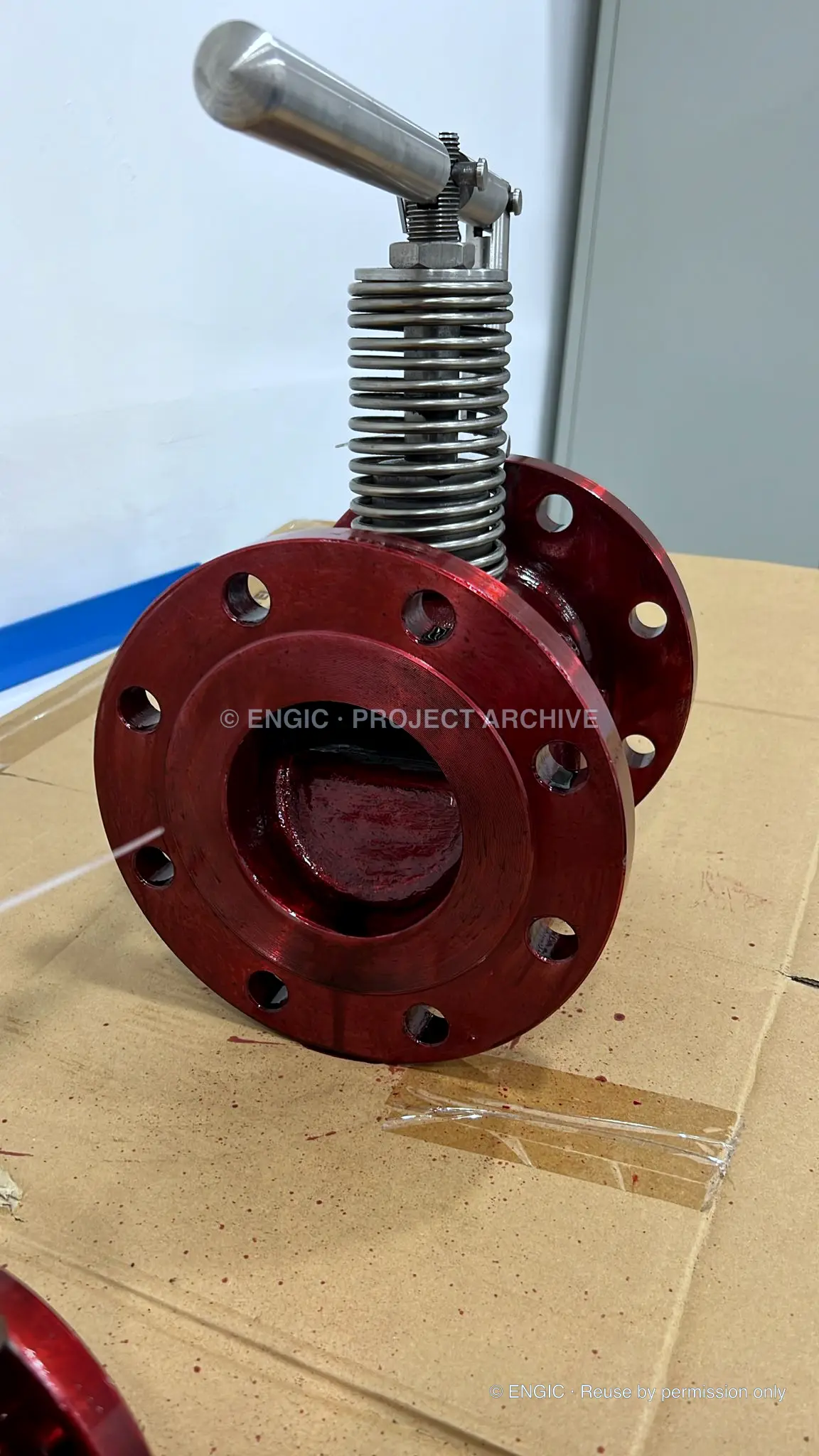 Valve bore and flange covered with red penetrant during surface inspection