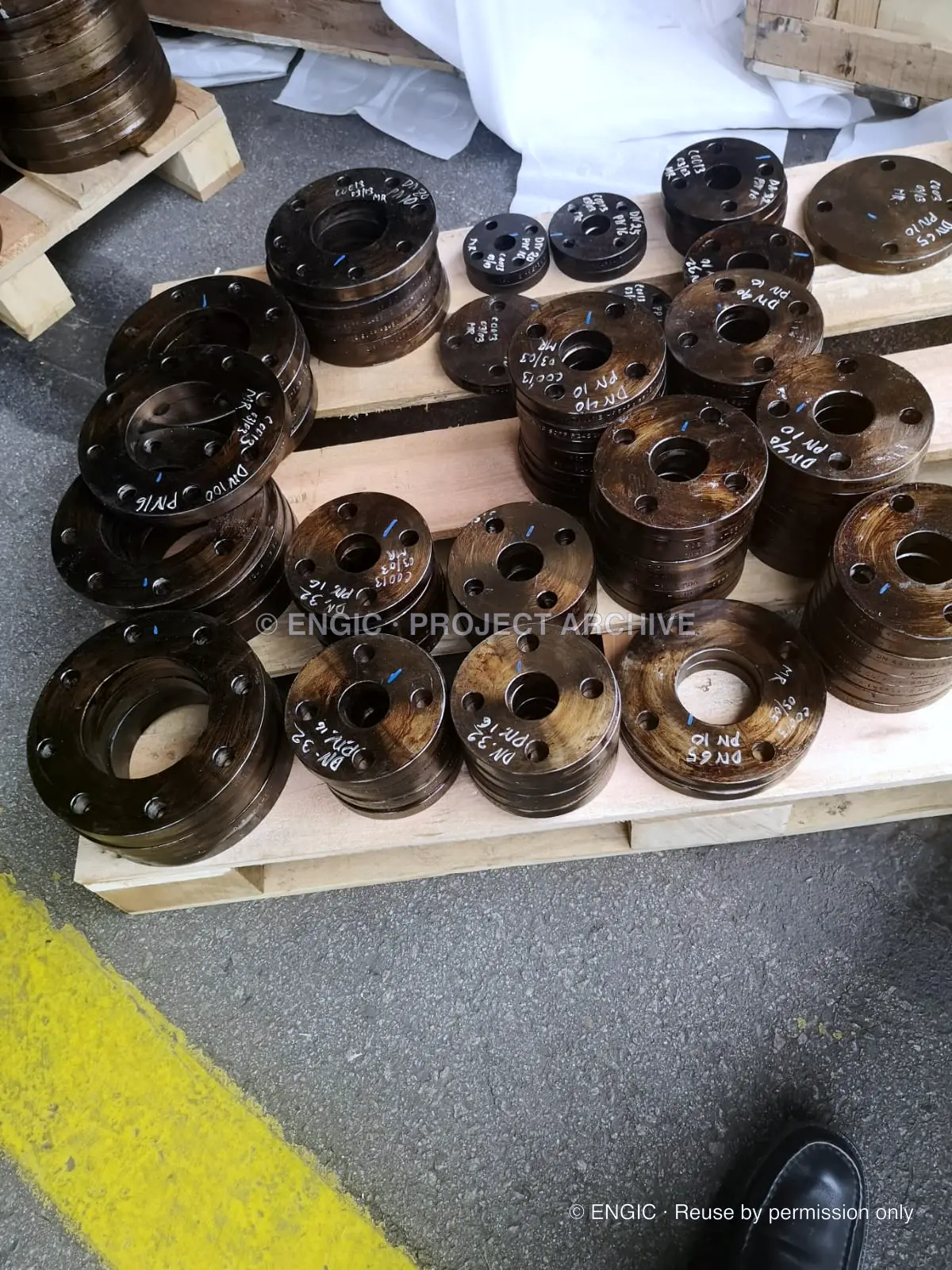 A dense array of drilled flanges laid out for checking