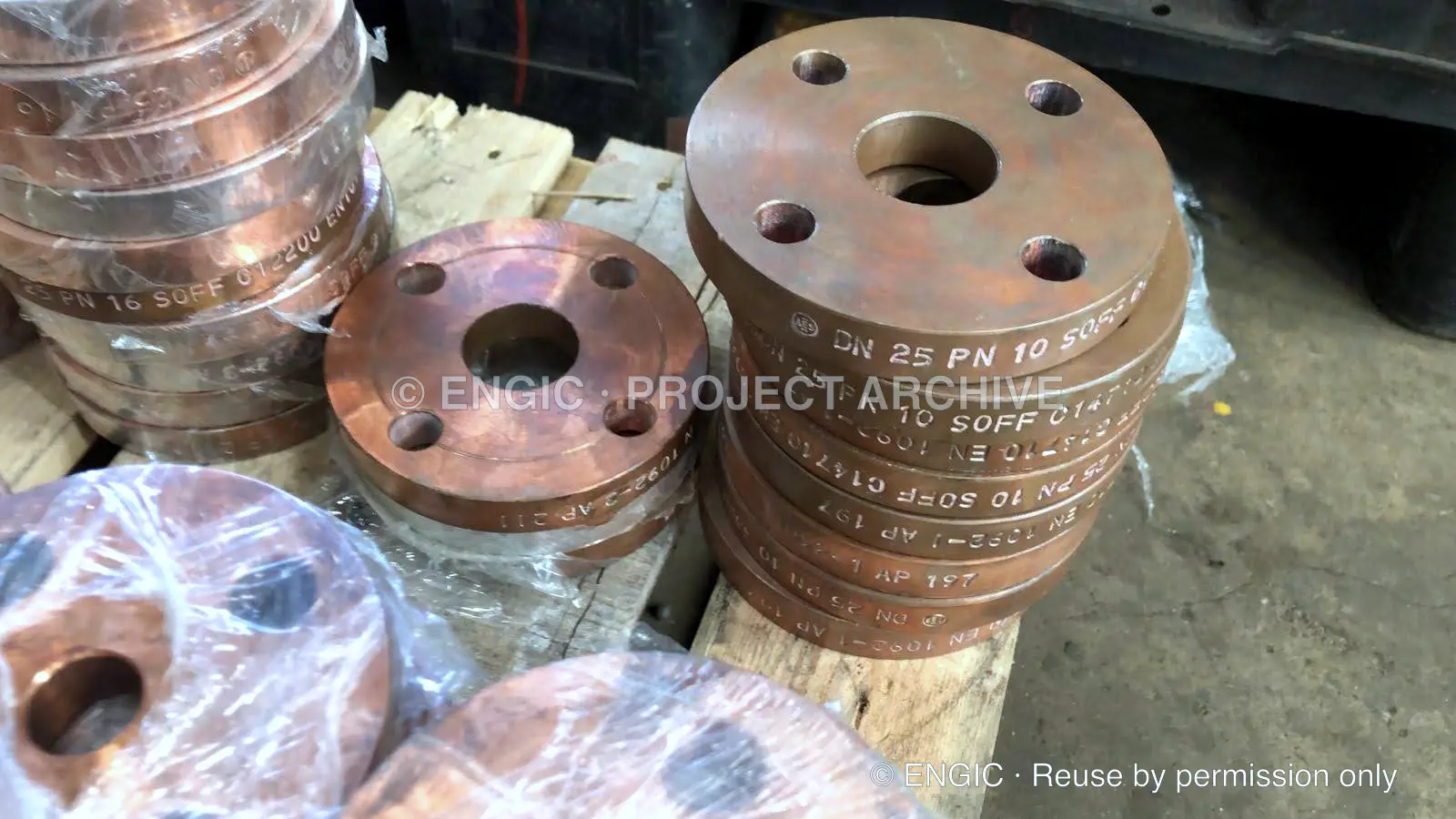 Stacks of bronze coloured drilled flanges on a pallet
