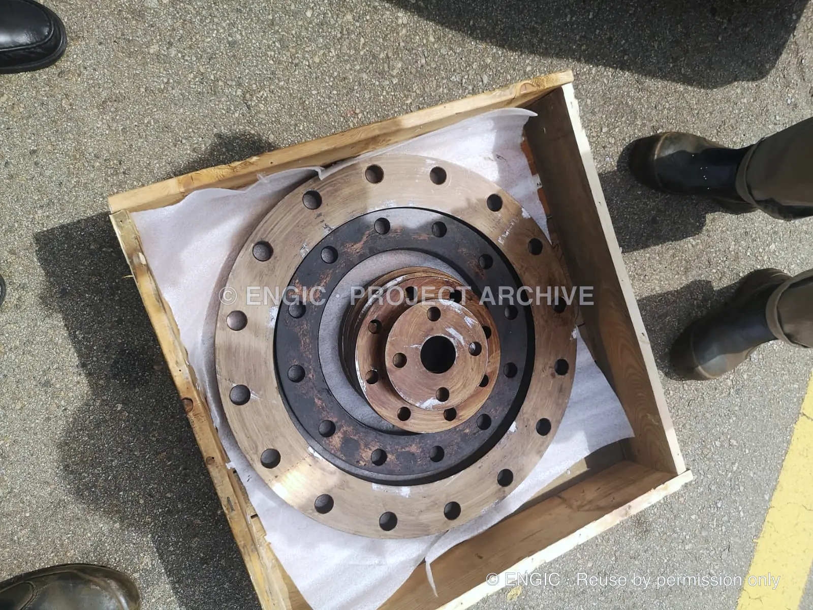 A large bronze flange packed and braced inside a timber crate