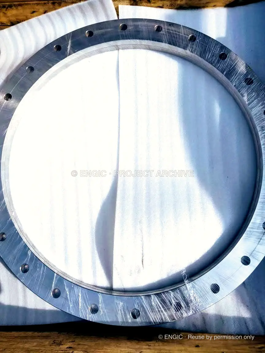 A large bright-machined flange ring protected with clear wrapping