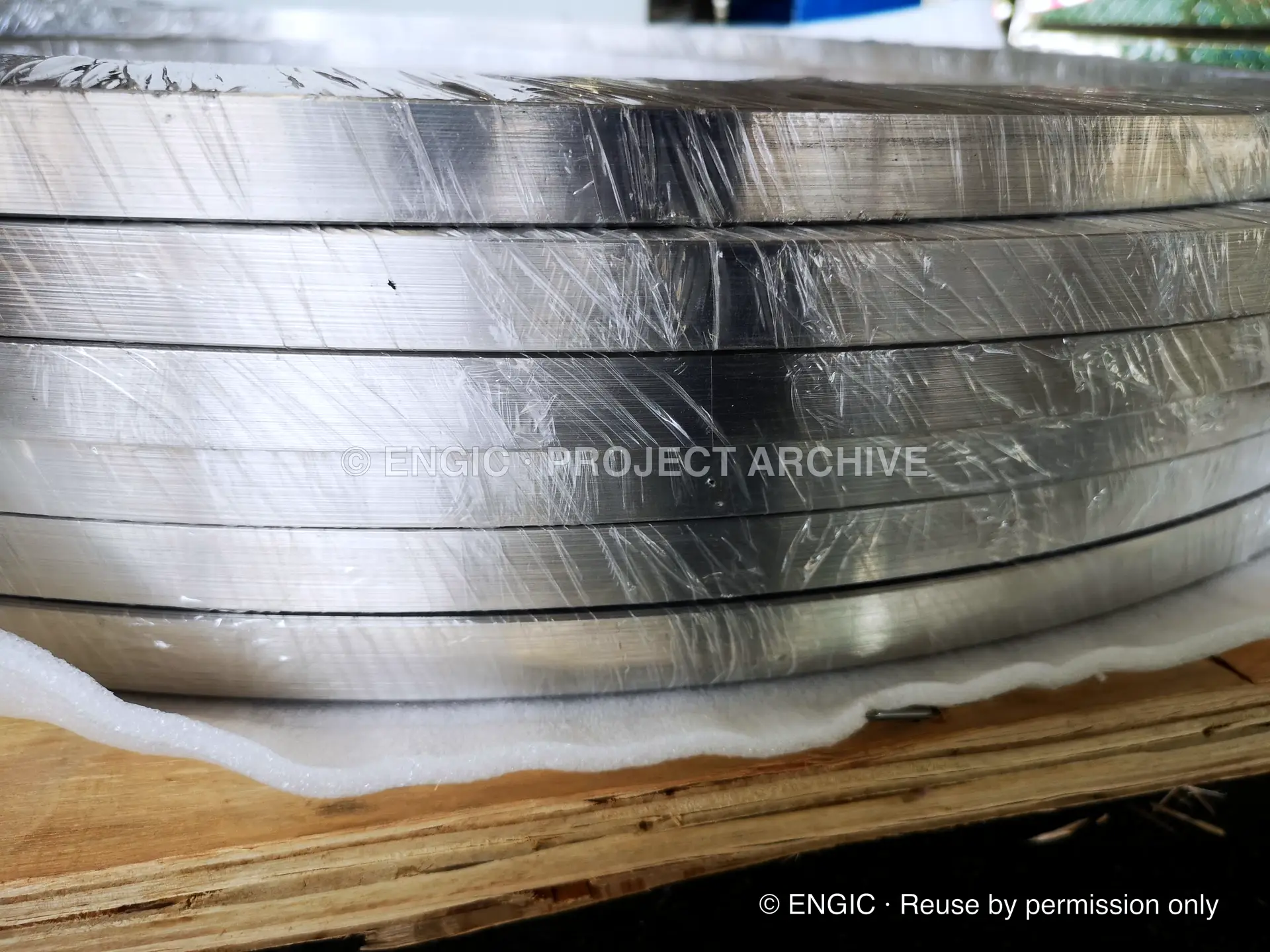 Wrapped machined flange rings stacked on a pallet
