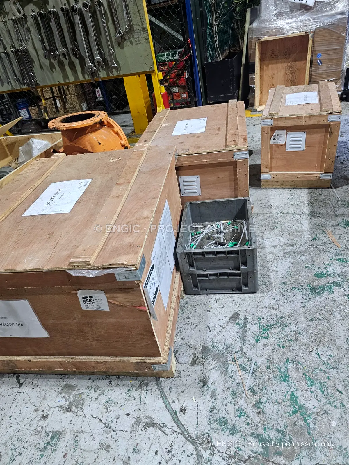 Labelled timber cases staged on the workshop floor for dispatch