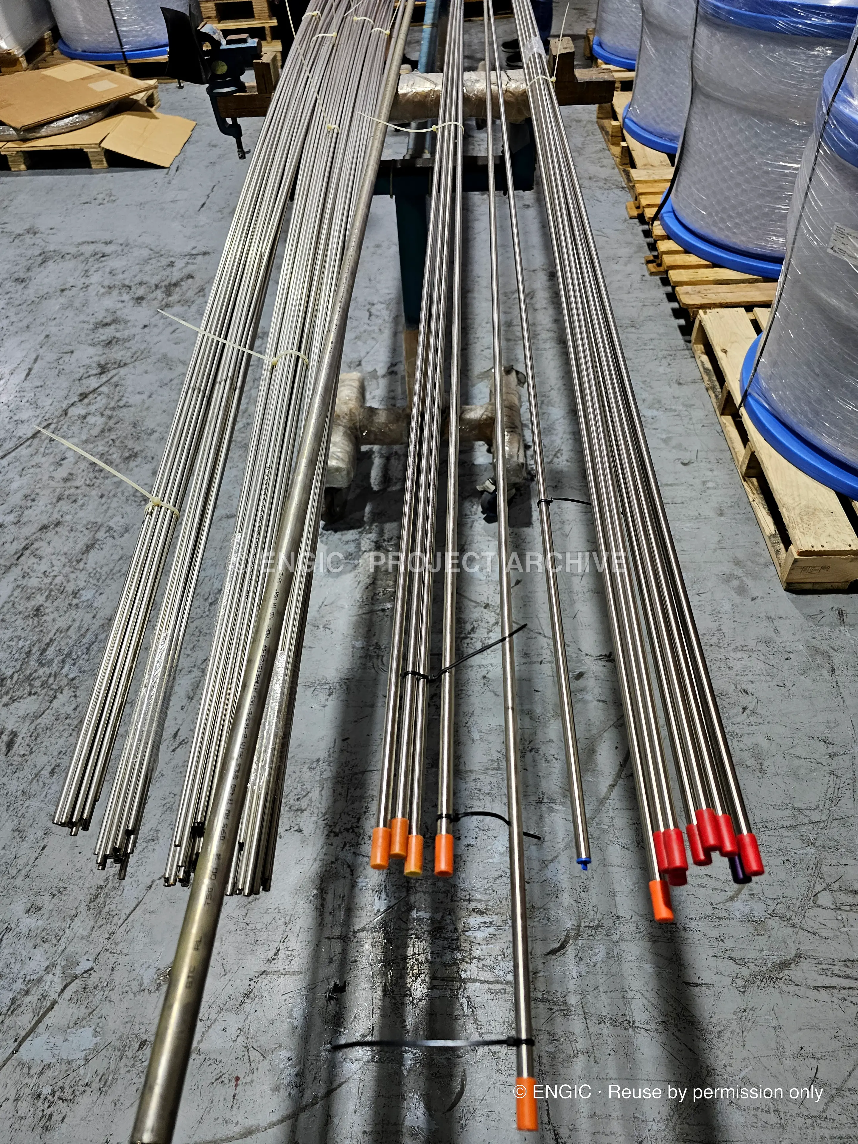 Bright stainless tubulars on pallets, ends capped and colour-coded