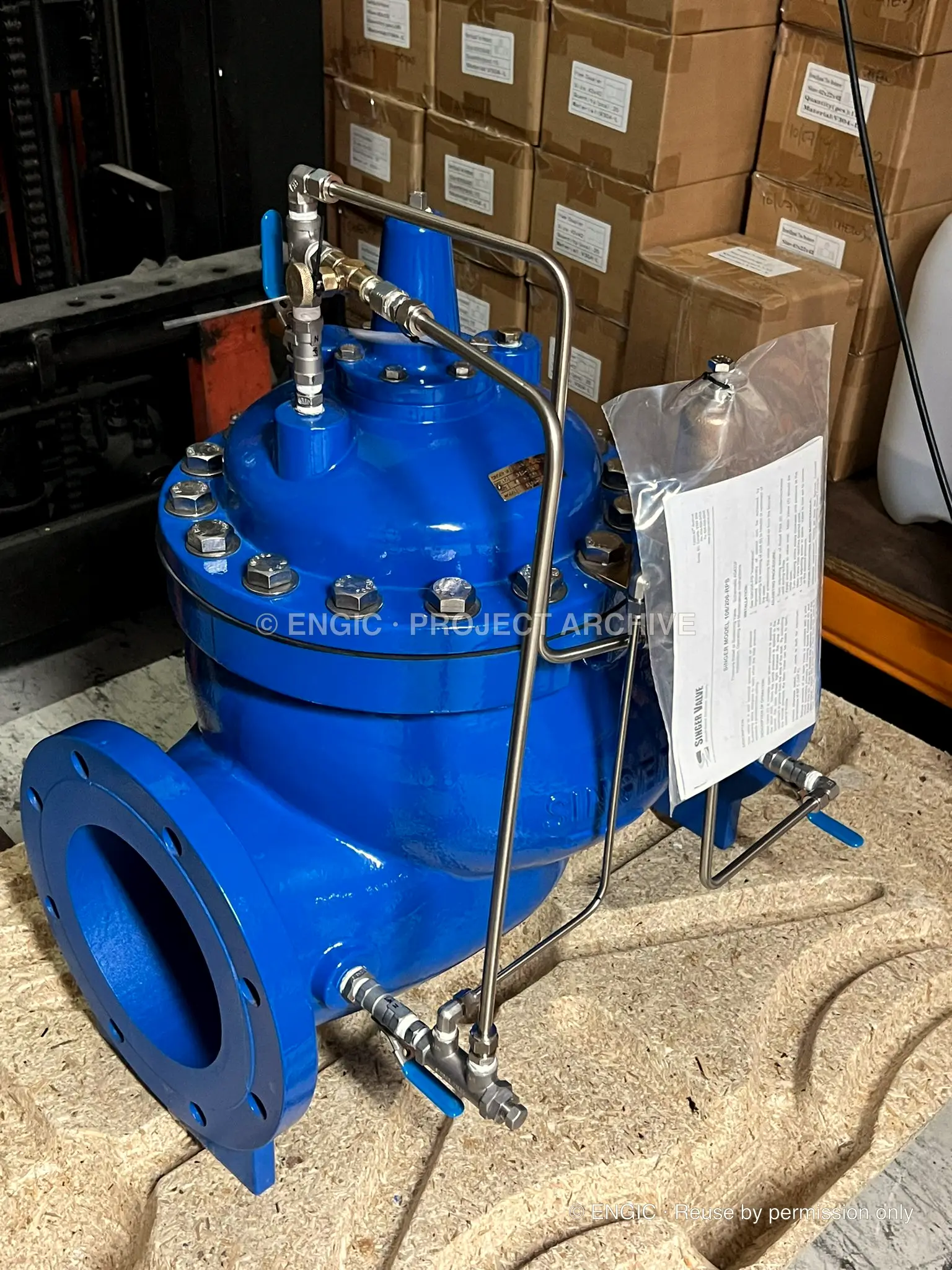 A blue pilot-operated control valve with stainless control tubing