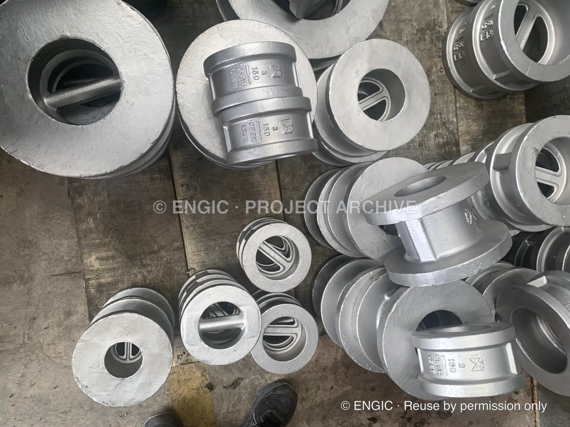 An assortment of cast dual-plate wafer check valves arranged for checking