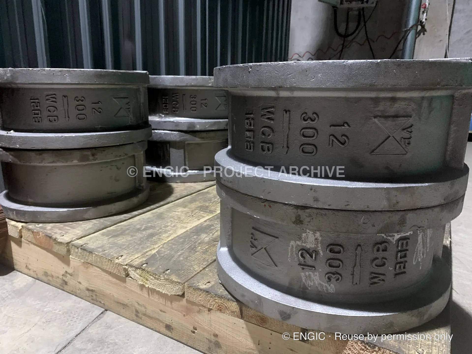 Large cast dual-plate wafer check valves stacked on timber pallets