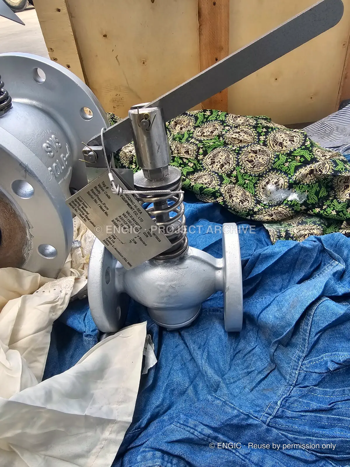 Two silver flanged lever valves set out together for checking
